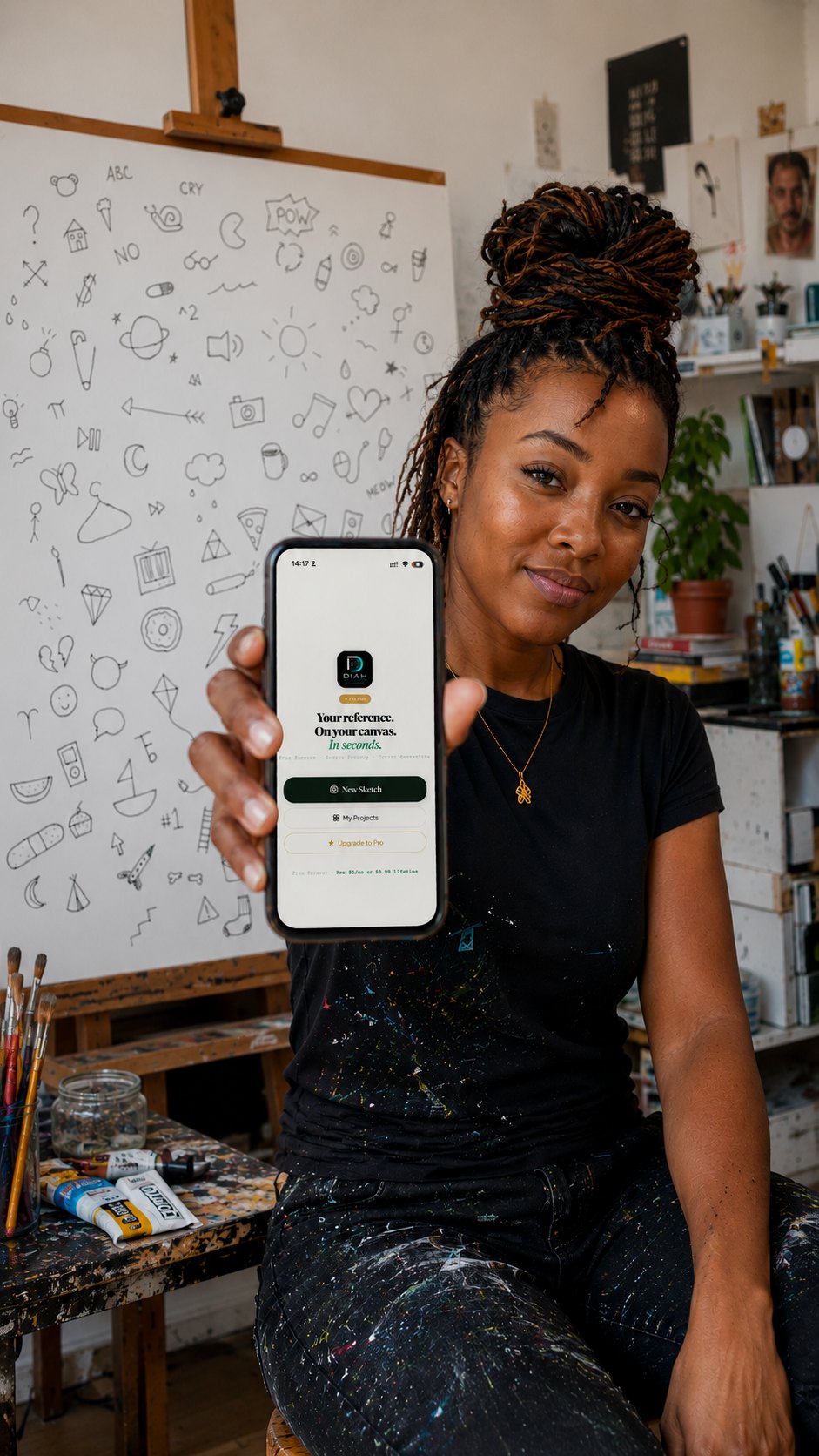 An artist in her studio holding a phone running Diah Sketch, a wall of doodle symbols behind her